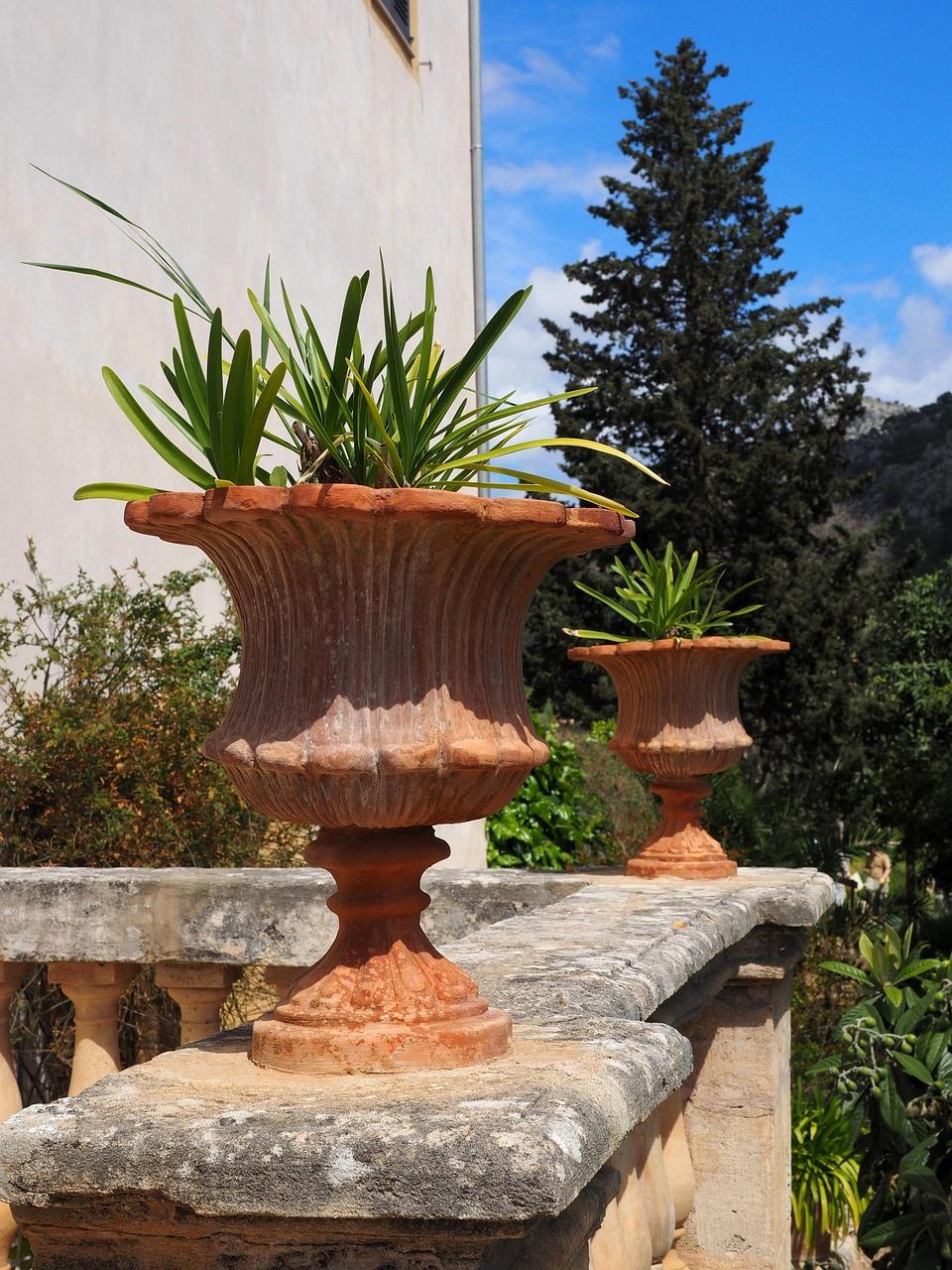 Various container pots stacked on balcony shelf